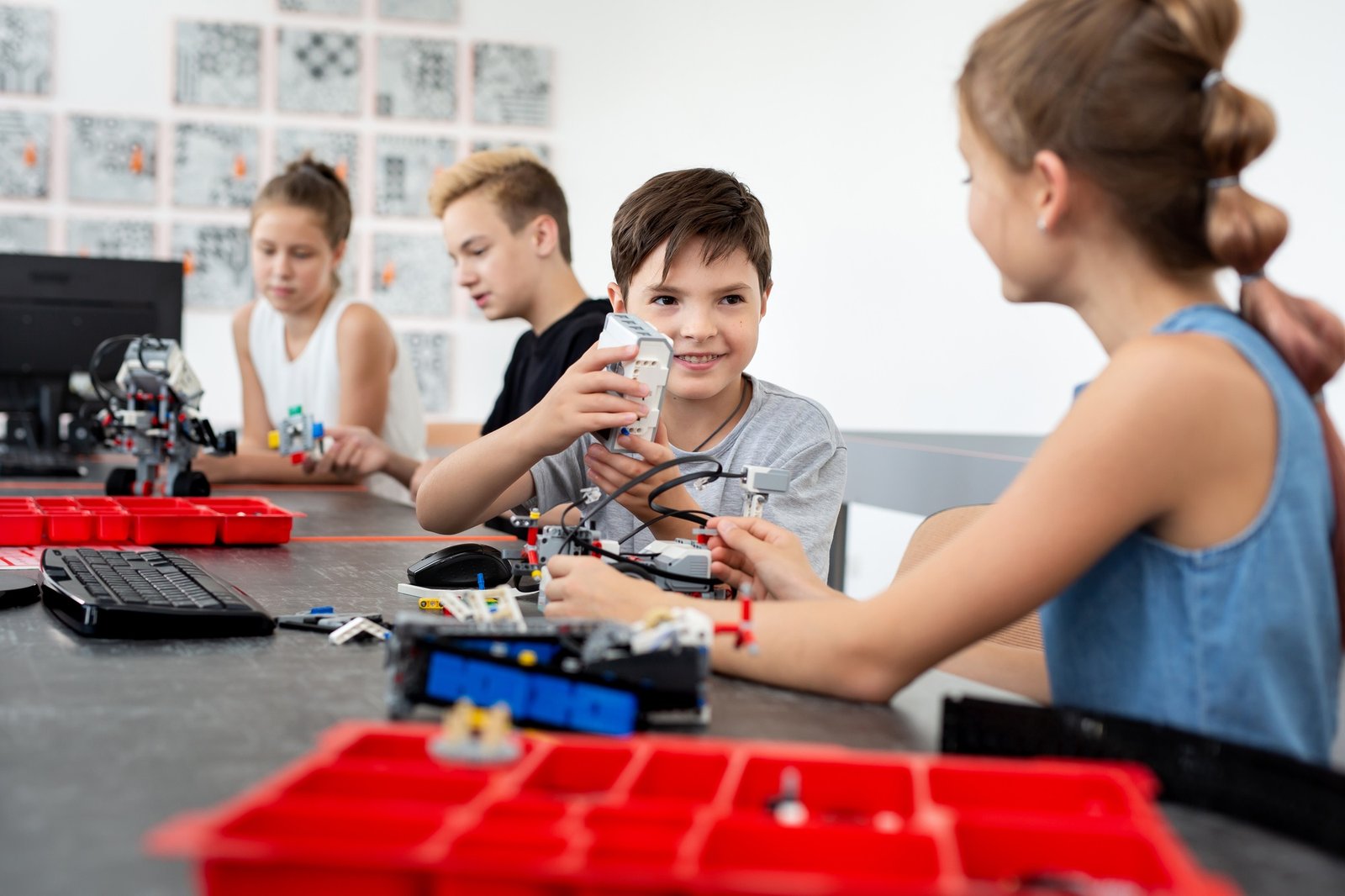 School children programs a robot in the classroom.